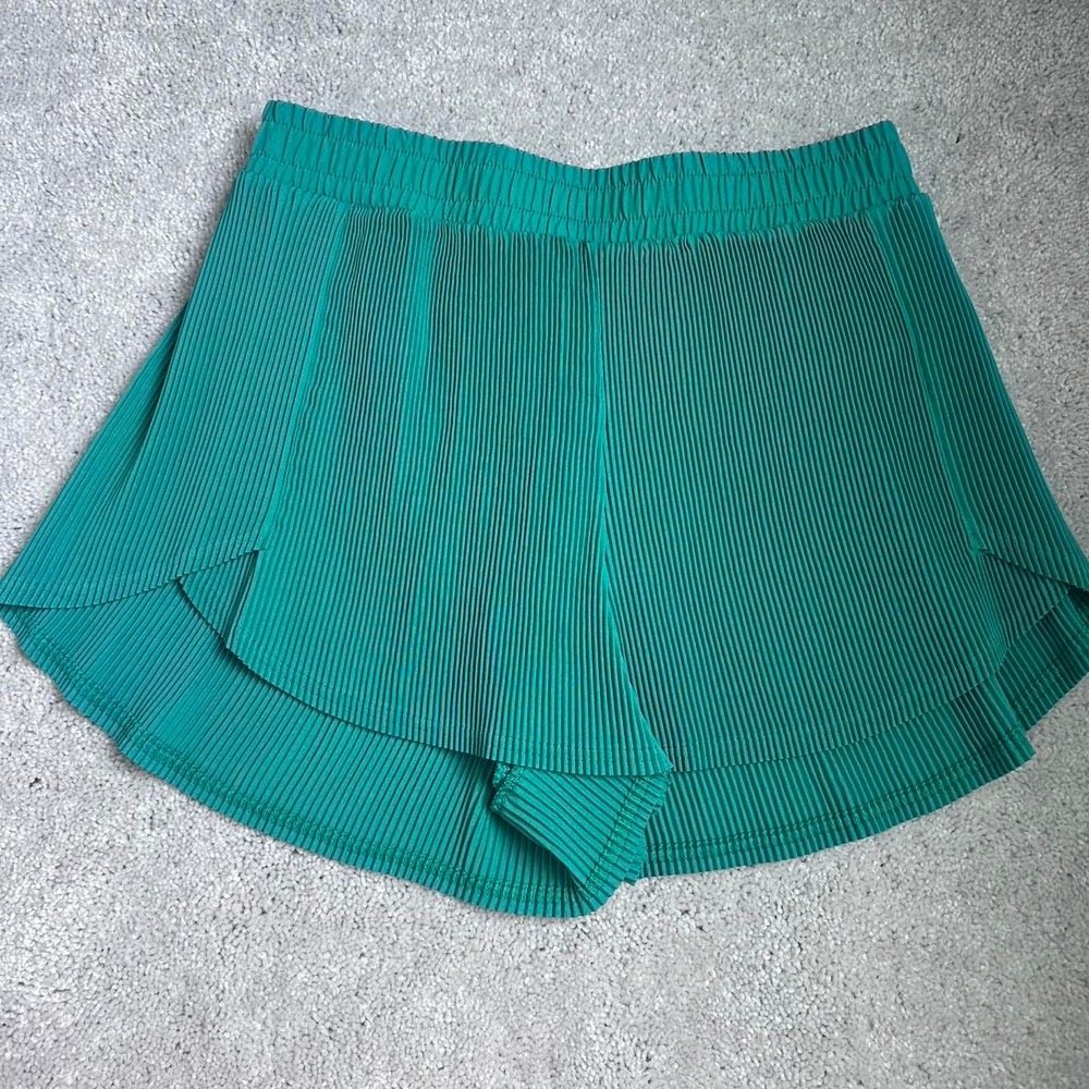green pleated shorts